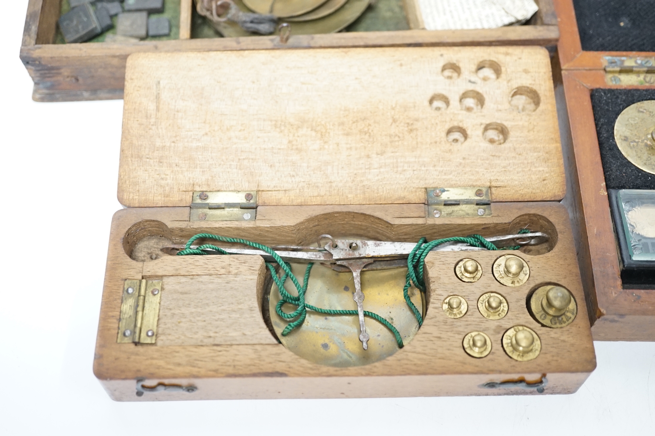 Four cased weighing sets, three of the sets with small scales included